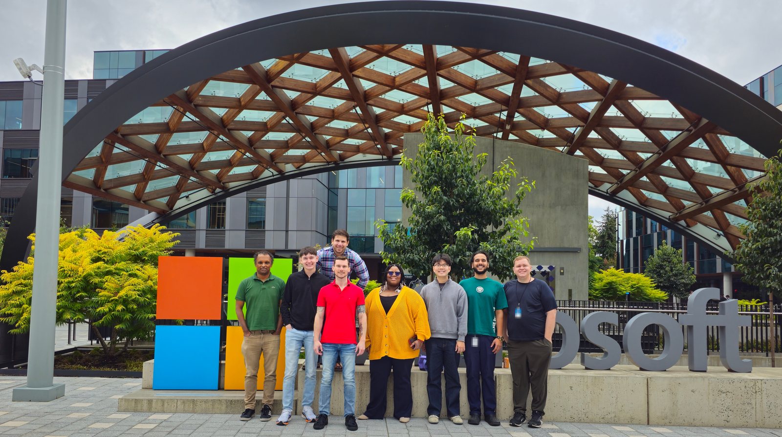 Bryan Totty with members of the Azure Storage security team in front of the Microsoft sign under the timber canopy